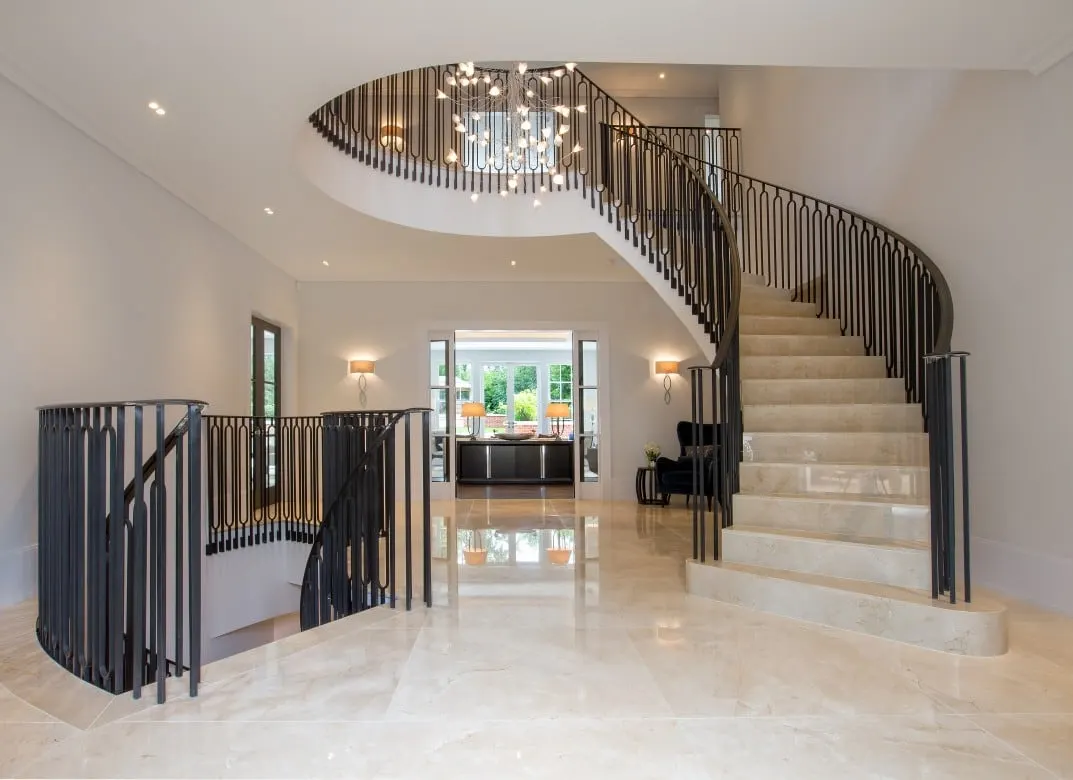 Entrance hall with a sweeping stone staircase, a marble floor and a chandelier, Kingston