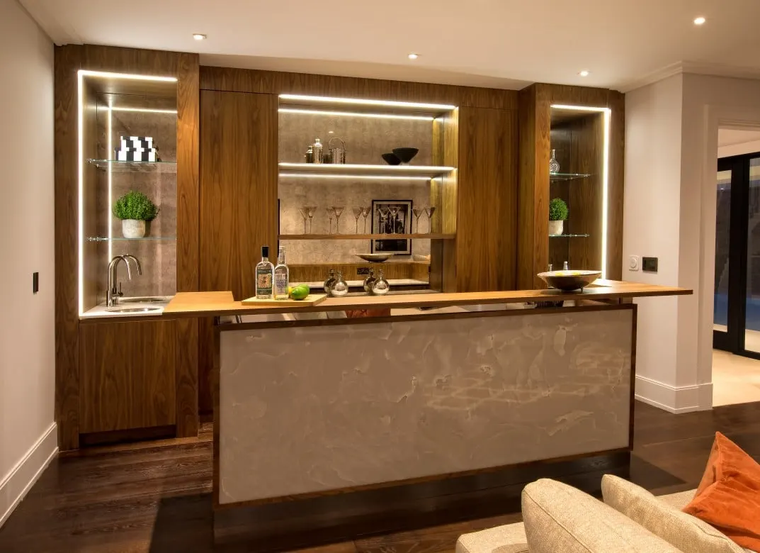 Home bar in walnut with backlit glass shelving, Kingston