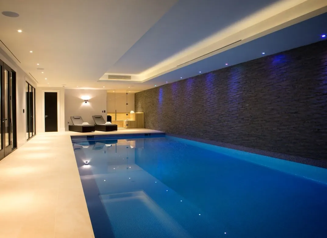 Indoor pool with a split-face slate wall and cove lighting, Kingston