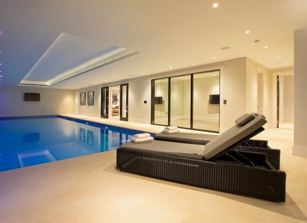 Indoor pool from the shallow end, with loungers on the stone surround, Kingston