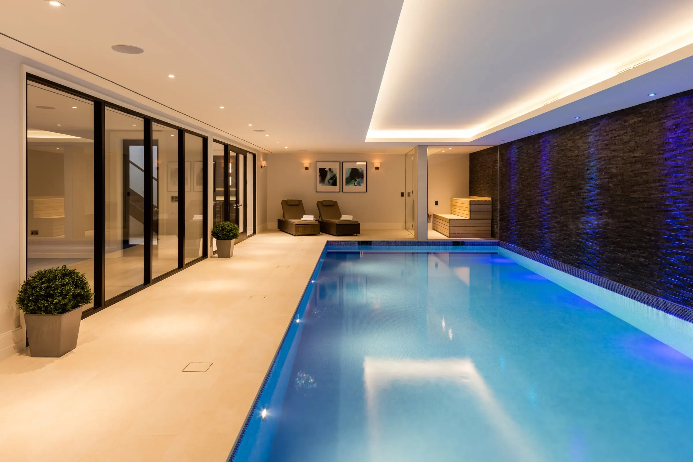 Indoor pool looking down its length, with black-framed glazed doors